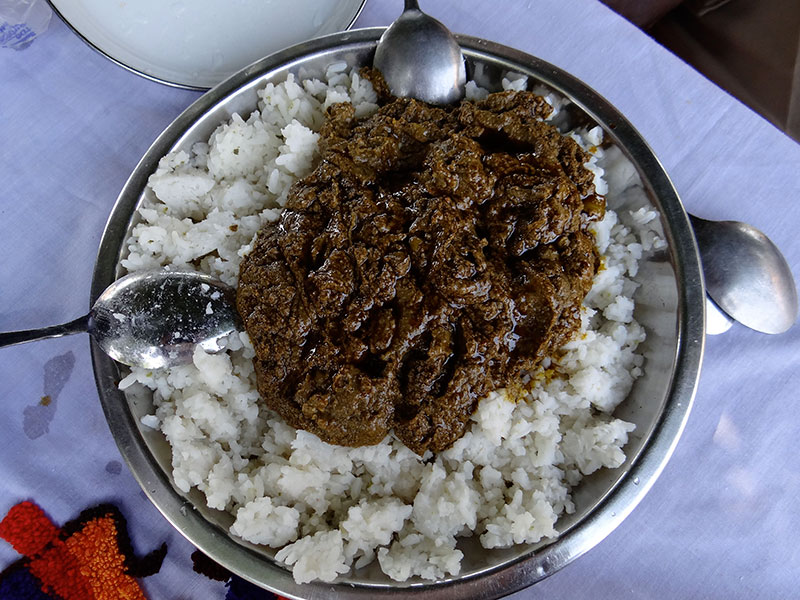 Cassava leaves served over rice without meat