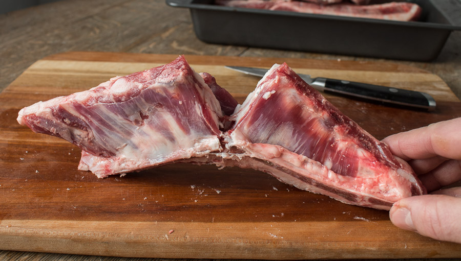 Cutting lamb or goat breast between bones and cracking