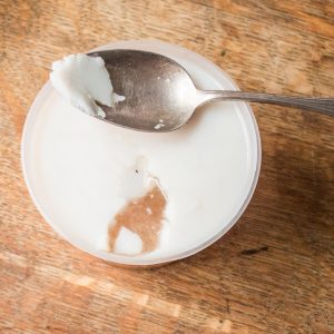 Skimming fat from lamb shoulder cooking broth