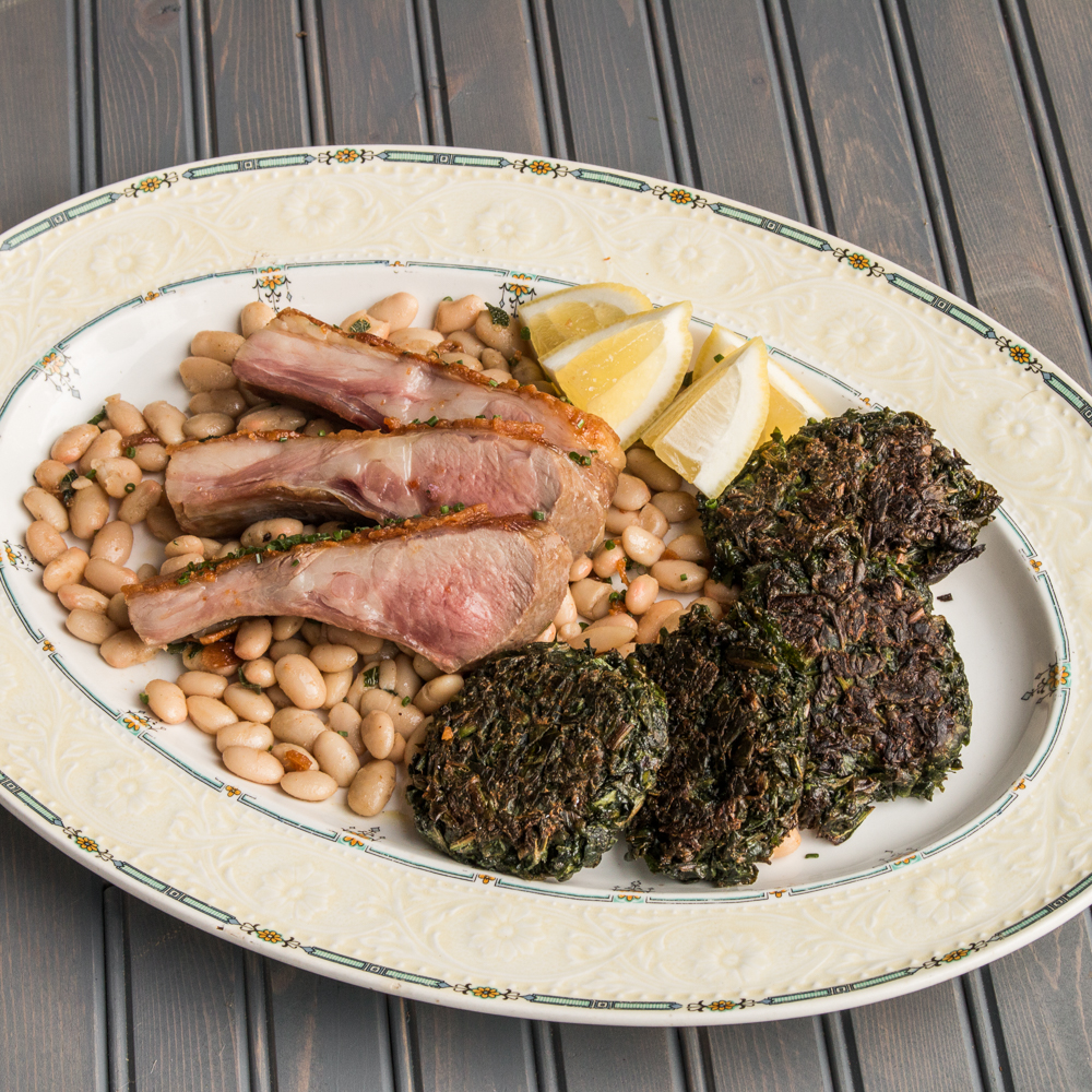Grass-fed rack of goat with white beans and foraged green fritters