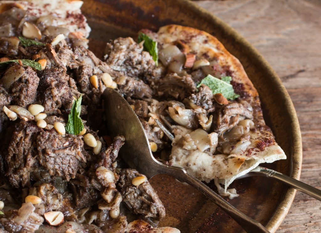 Lamb or goat mousakahn with sumac and onions