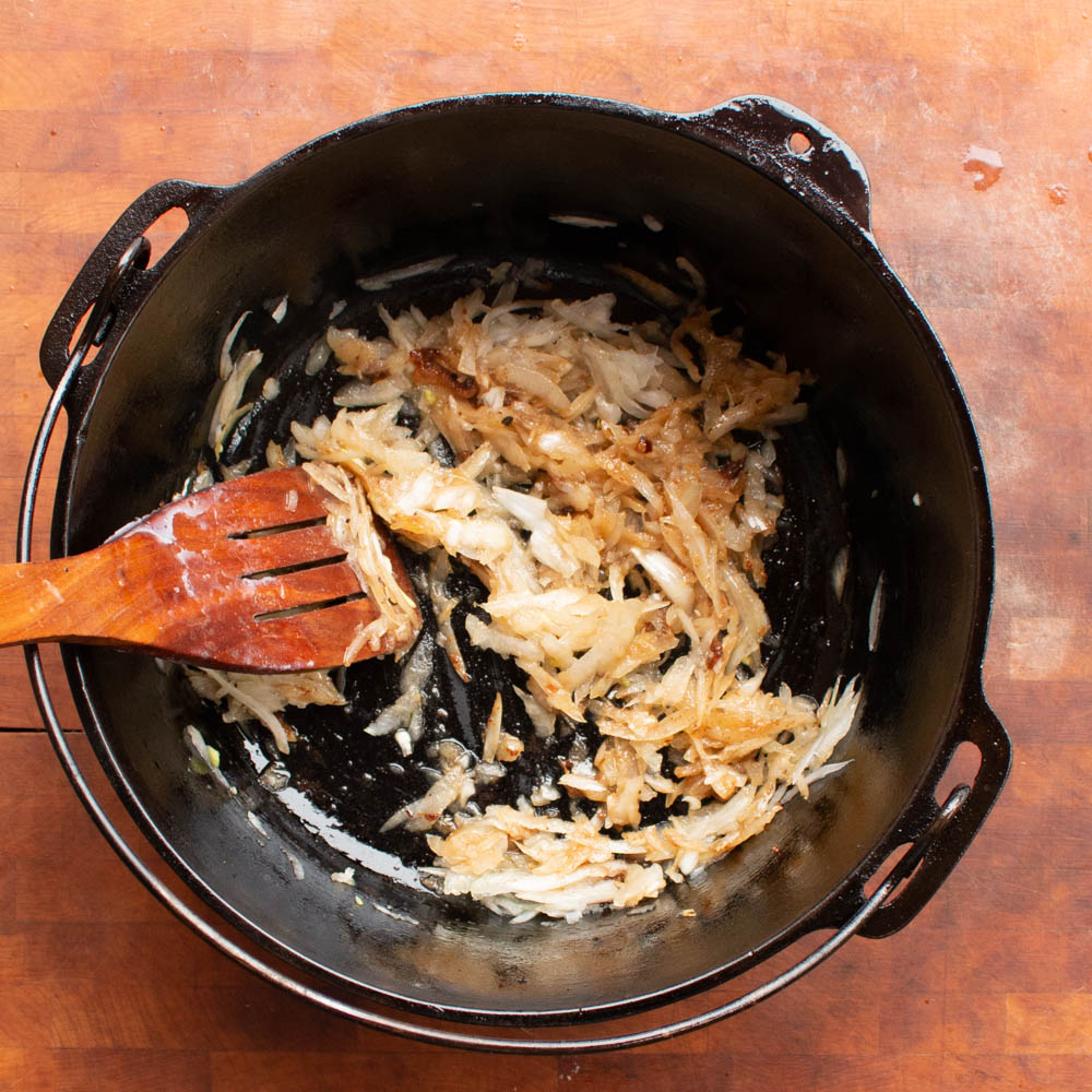 Adding onions to the garlic and anchovy