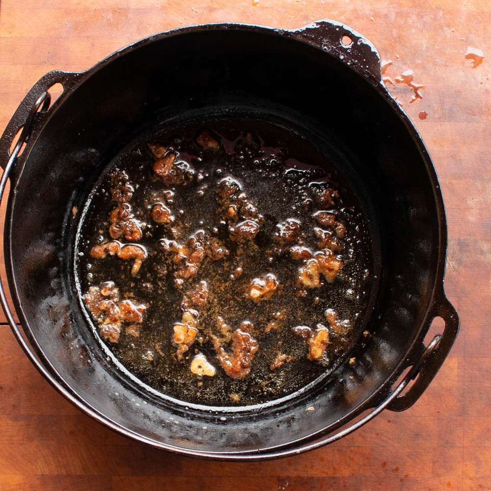Cooking and garlic and anchovies for goat ragu with olives