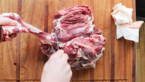 Cutting a lamb leg into roasts