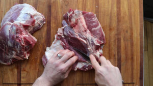 Cutting a lamb leg into roasts