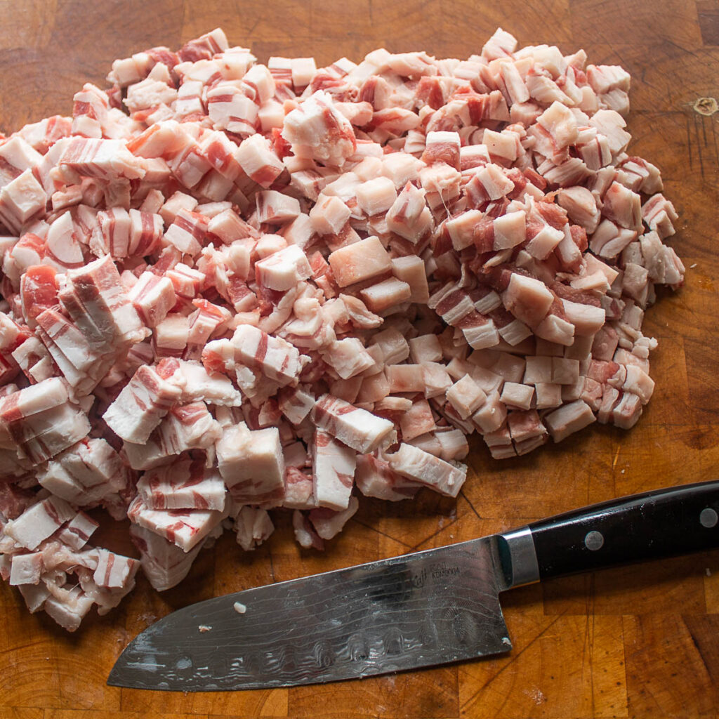 Cutting lamb fat caps for chicharrones de borrego