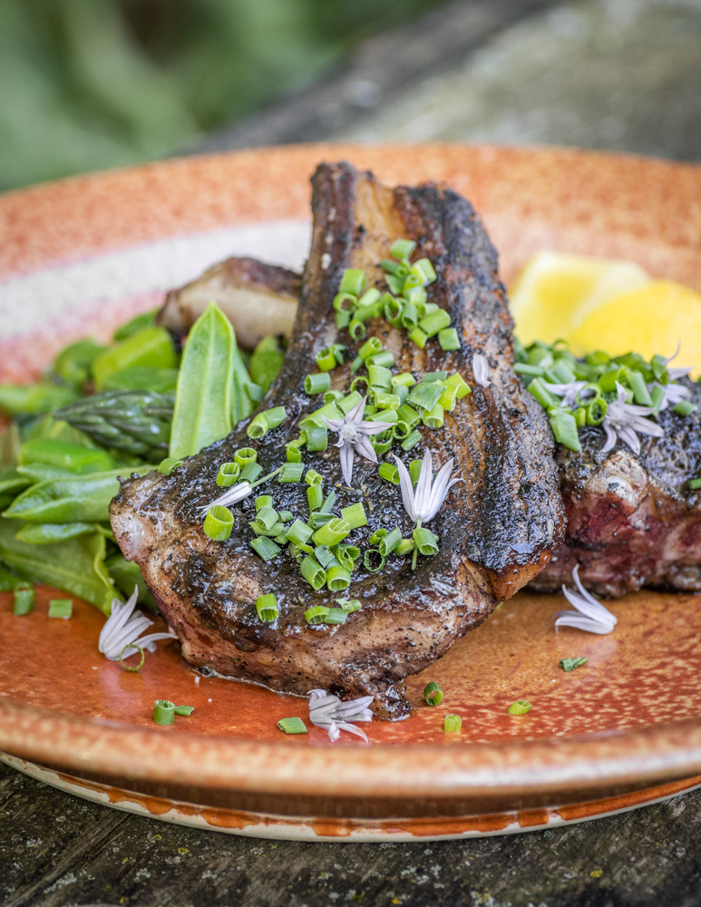 Black trumpet mushroom crusted goat chops with milkweed shoot and asparagus salad