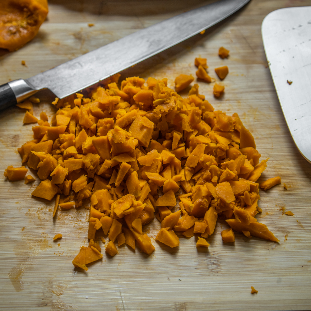 Chopping cooked squash for lamb hand pies