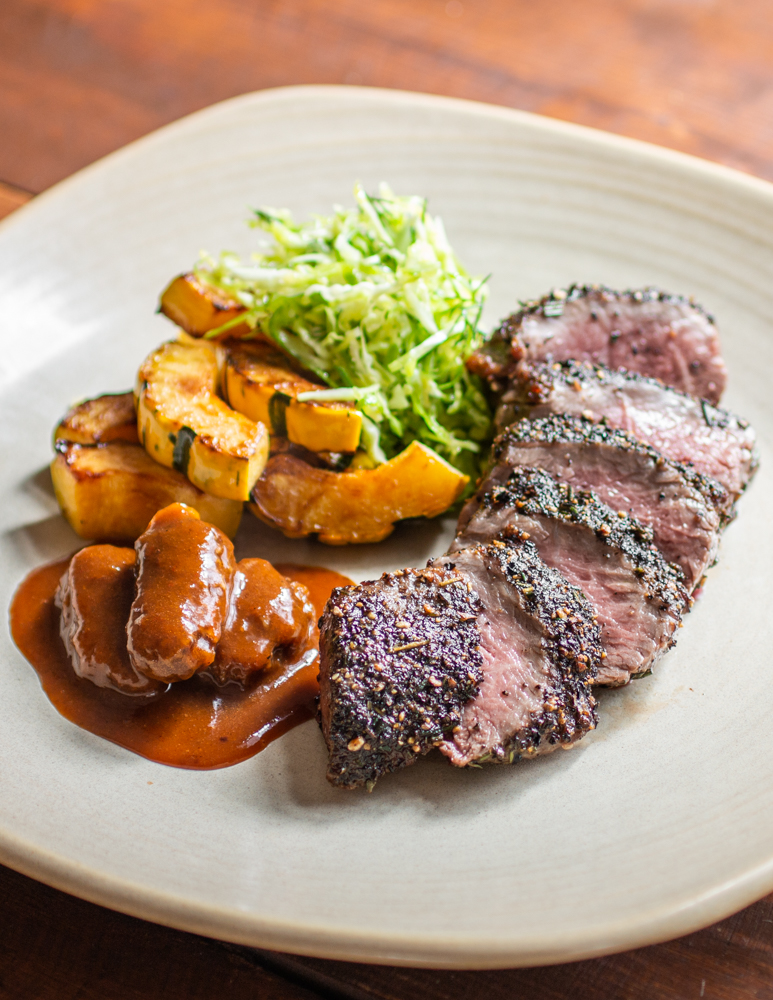 Black pepper and rosemary crusted lamb loin with morel mushrooms, squash and shaved brussels sprouts