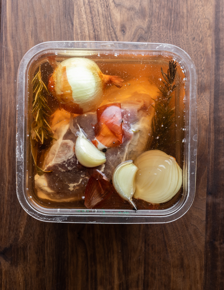 Leg of lamb in a cambro container with brine