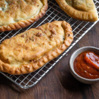 lamb or goat sausage calzones with spicy tomato sauce