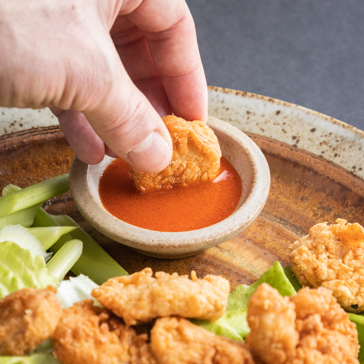 dipping lamb fries in sauce