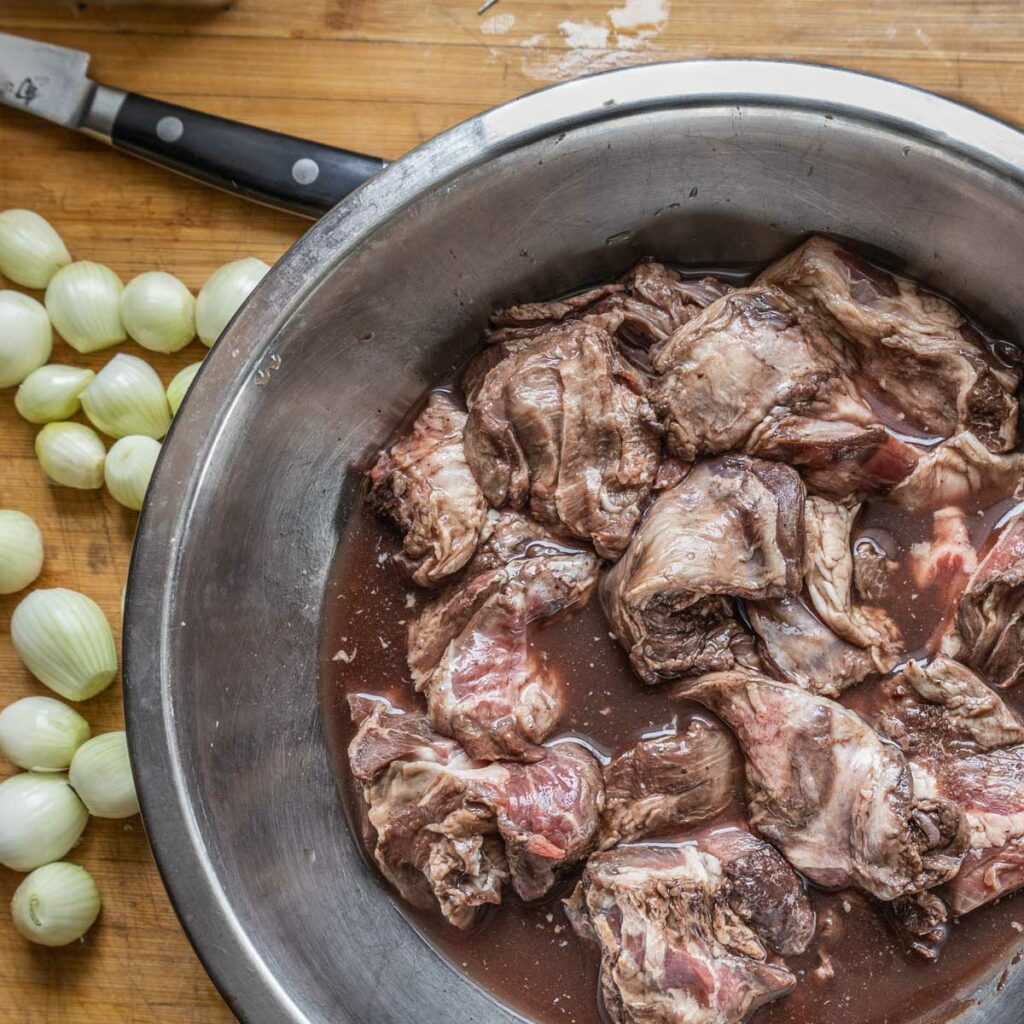 marinating goat neck pieces in red wine