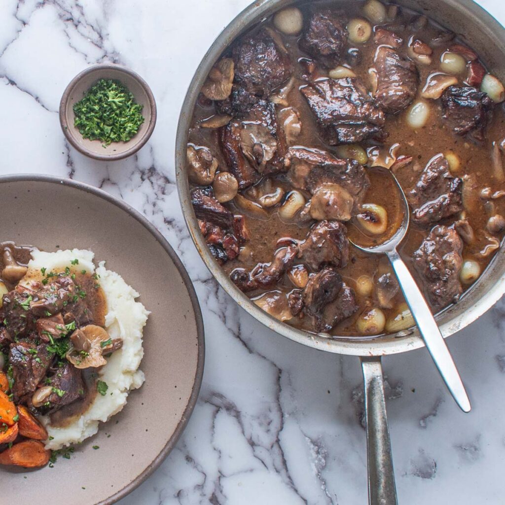 goat neck stew with red wine and mushrooms