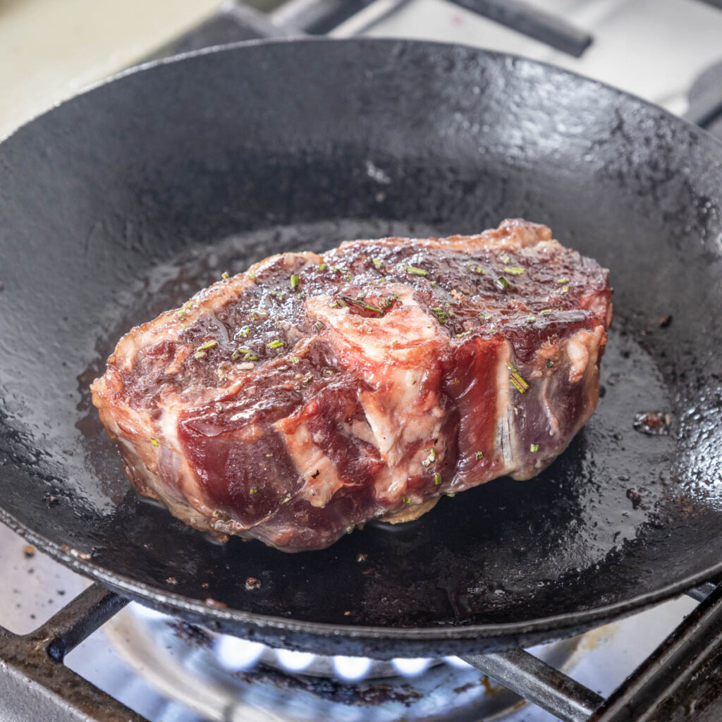 cooking a barnsley chop in a cast iron pan