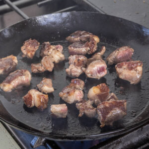 browning lamb meat in a pan