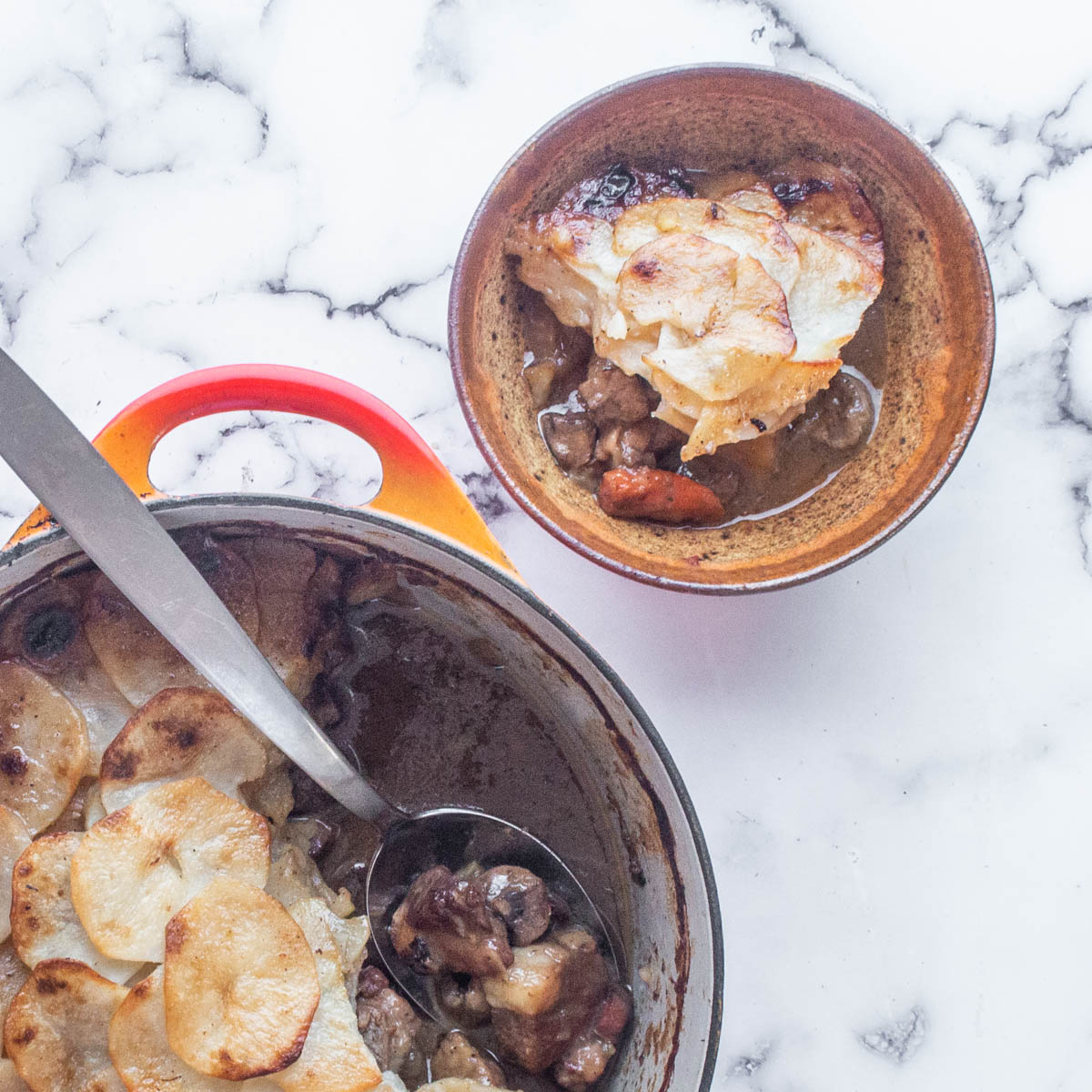 spooning lancashire stew into a serving bowl